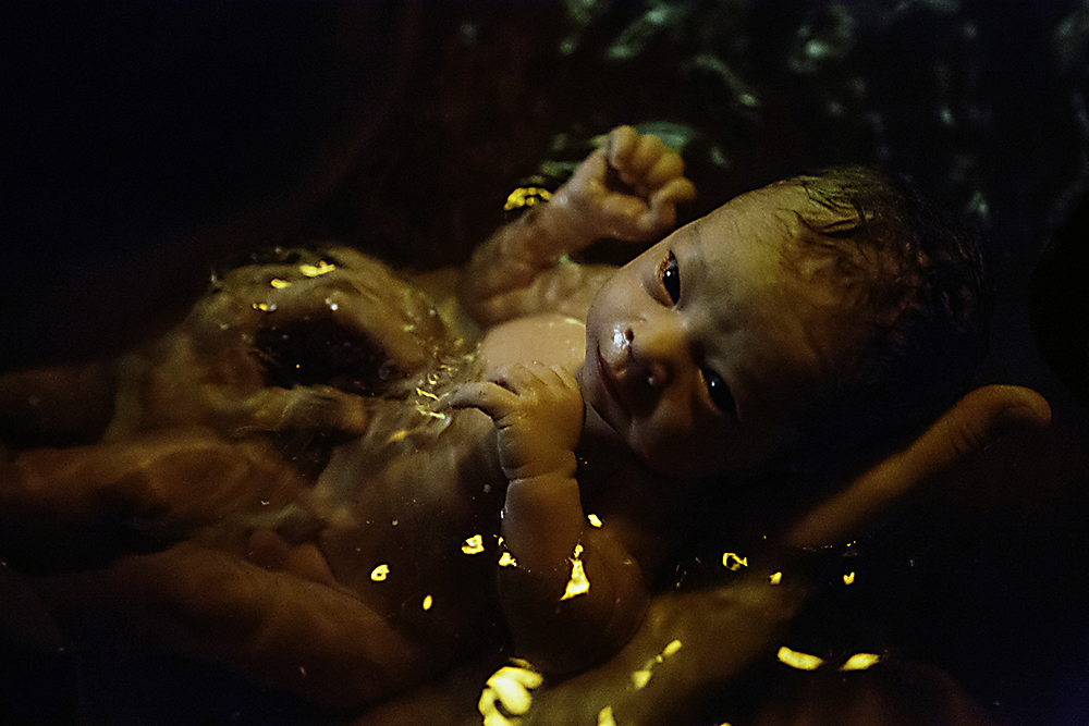 Newborn soaking in birthing pool